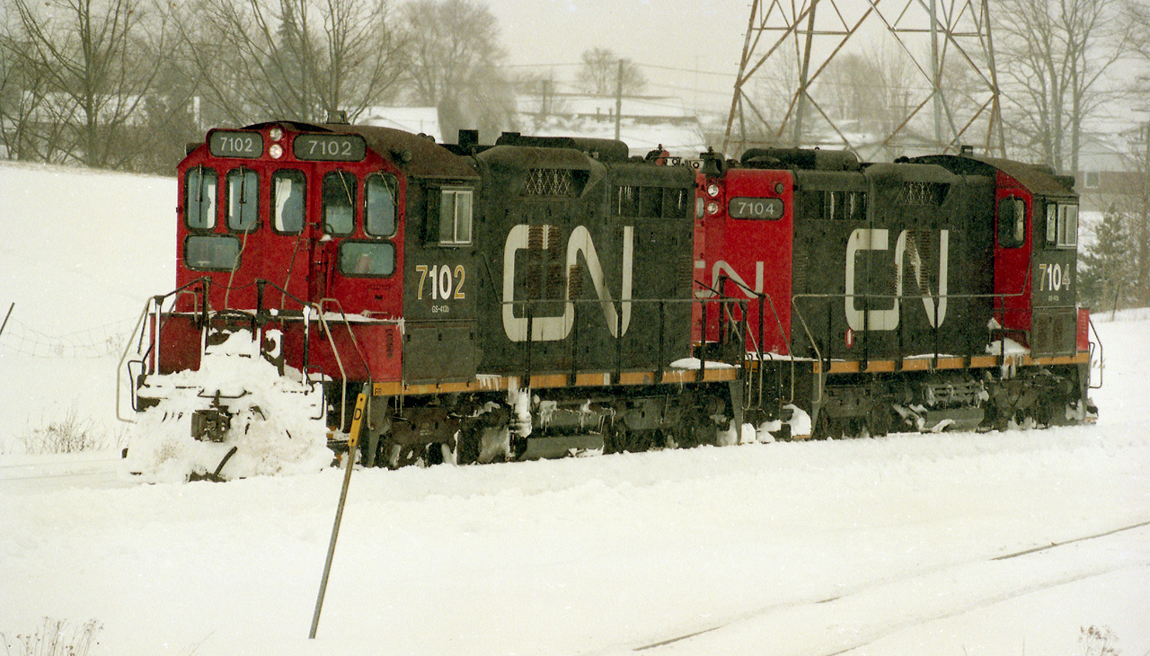 Here is a photo of a pair of 7100's working the Geco Spur in Scarborough.  This was a nasty January day, likely 1992.  They were servicing the GM Van plant on Eglinton Ave, and it closed in 1993. I have another frame showing these locos alongside a 1200RS, so there was quite a lot of traffic in those days.  But now the tracks are gone, the locos are gone and the picture was shot from the parking lot of Warden Woods, a newly opened shopping mall, but today it has gone too.