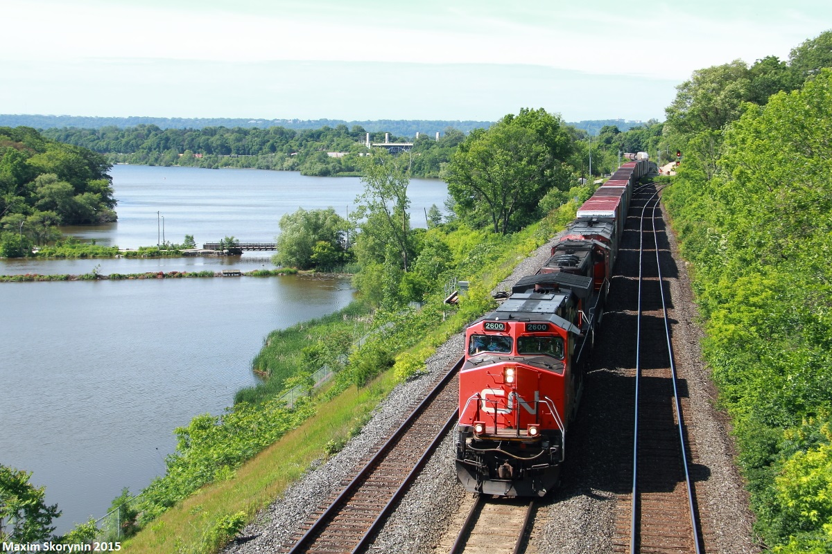 CN A42231, a daily Fort Erie to Toronto manifest rolls by the 21st annual railfan meet-up at CN's Bayview Junction with a variety of General Electric products for power.
