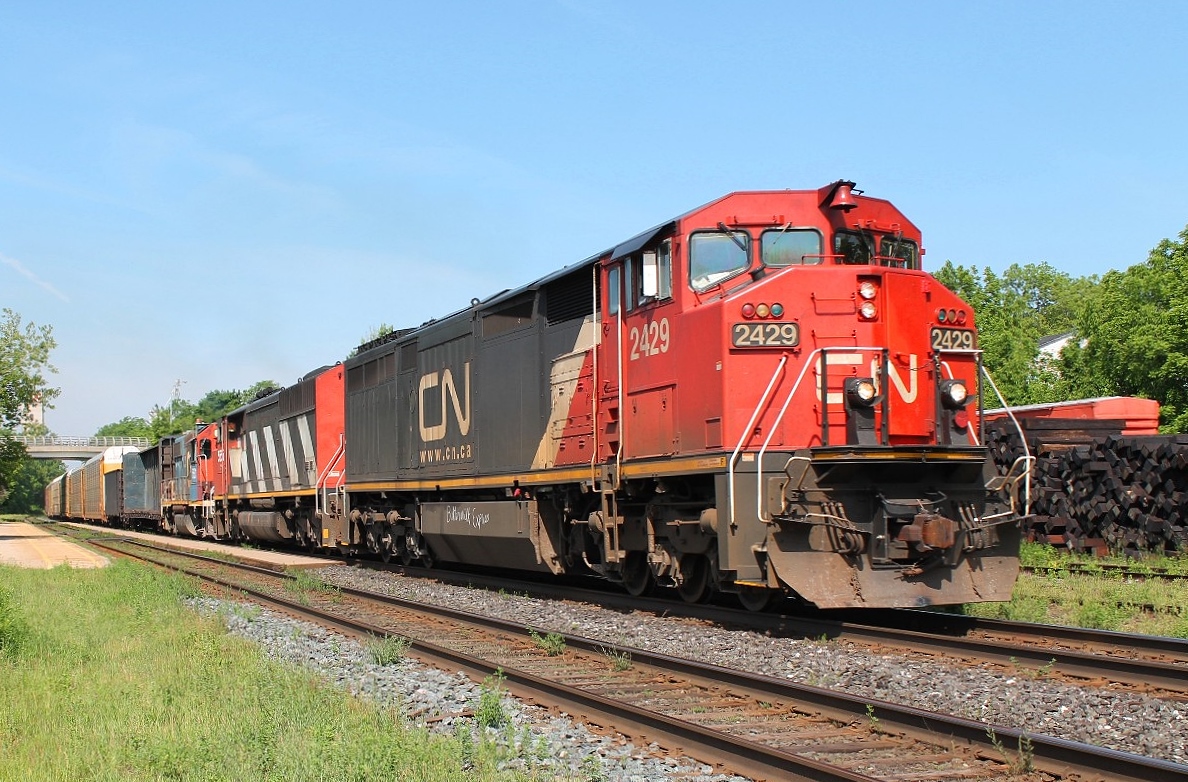 The "Buttermilk Express" if you believe the graffiti on the fuel tank of 2429 leading CN 5555 and GT 5831 on a slow moving mixed freight.