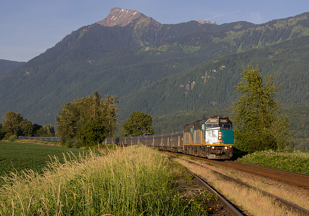 An extremely late Via #1 Canadian hustles at 70mph westward through the eastern Fraser Valley, as Mount Cheam towers high above on a gorgeous, Summer like day. The Canadian has been experience a number of delays in 2015, making late trains such as this one a common sight.