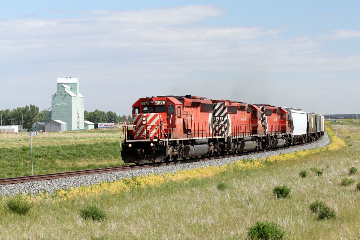 With a perfectly matched set of classic SD40-2s in multi-mark paint, the northbound Coutts turn returns to Lethbridge with BNSF interchange traffic. Just here the train is on a relatively new bypass that goes around the town of Milk River.