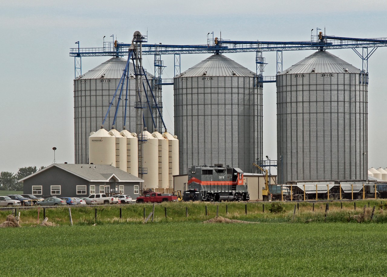 Dwarfed by the grain bins former DMVW 6327, GP35, now owned by Providence Grain, sits at the Gaudin Elevator north east of Fort Saskatchewan.