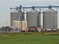 Dwarfed by the grain bins former DMVW 6327, GP35, now owned by Providence Grain, sits at the Gaudin Elevator north east of Fort Saskatchewan.
