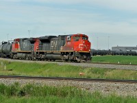 SD70M-2 CN 8824 and DASH9-44CW approach Scotford Yard on CN's Vegreville Sub, this day diverted from theire normal route on the Wainwright Sub due to trackwork.