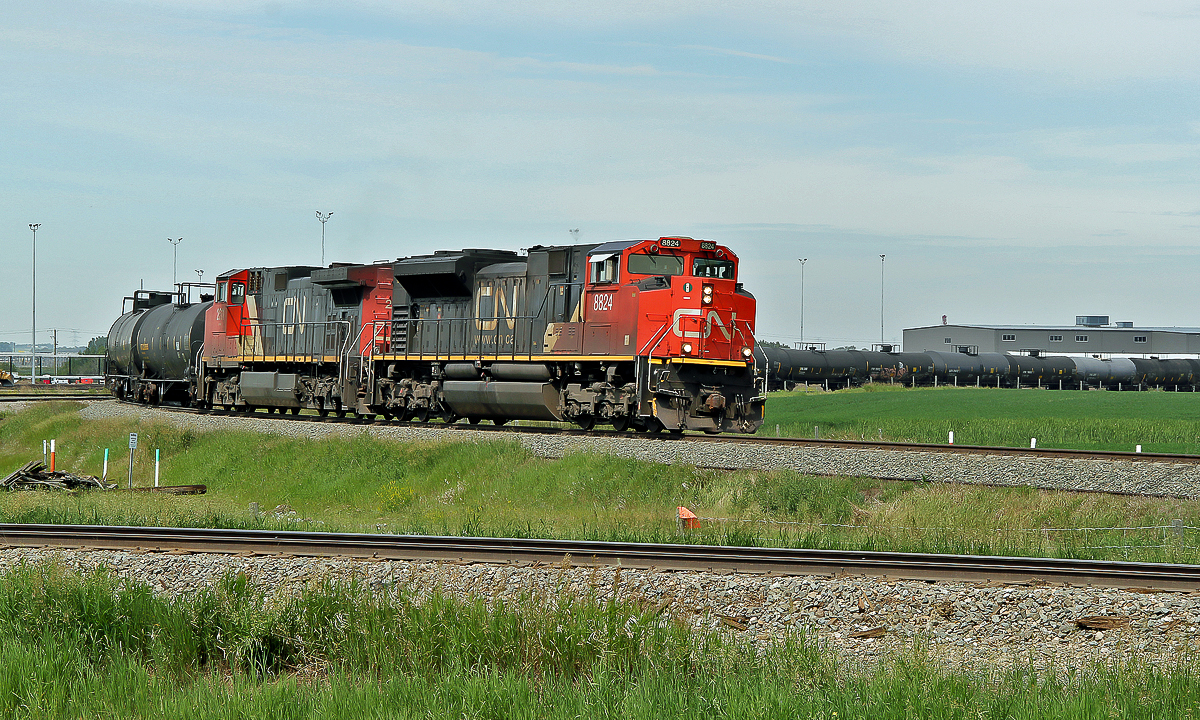 SD70M-2 CN 8824 and DASH9-44CW approach Scotford Yard on CN's Vegreville Sub, this day diverted from theire normal route on the Wainwright Sub due to trackwork.