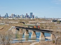 With a nice city of Calgary backdrop, this CN local is returning to Sarcee yard after switching the foothills industrial area. Crossing over the Bow River, this bridge had some damage two years ago in the Calgary floods. You could not imagine how much time in the past few years I have spent up on top of this ridge waiting for a train, going the right way. Most of the time I see them pushing their train back to the yard. 