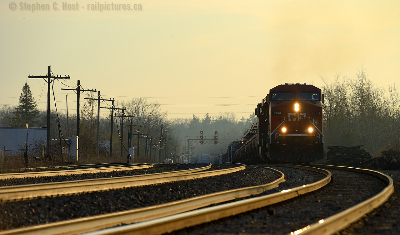 The Golden CrestCP Train 246 is riding the high-iron in style, with the first light of the day gilding the sky, and the rails, a deep golden hue. Cresting the grade at Guelph Junction, the crew of Train 246 will trade their royal rails for sunglasses as the railway makes a sharp turn south toward Hamilton and Buffalo. Like a roller coaster, the crew of 246 has two more grades to conquer before reaching Buffalo, Essar Stel loads on the head end will challenge downgrade at Waterdown, and the extra tonnage lifted at Hamilton will resist the upward climb to Vinemount, and the journey only half done at that point One can see why the TH&B decided to build along the Lakeshore (resulting in the granting of Joint Section Rights on the Oakville Subdivision which ended only 5 years ago) to avoid this roller coaster action, but as we now see, CP has made their choice and this is how they prefer it, pushers and all.