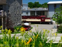 <b>Peekaboo:</b> OSR's only active RS18 (at present) 181 with 505 (MLW RS23) is passing by the Guelph Youth Music Centre, and the Stewart Lofts and Condos in Guelph, both which straddle Cardigan St along with the Railway. Would you live here? Lots of condos currently for sale :)<br><br>
40 years ago, both CN and CP had tracks here, CP had a piggyback ramp, an interchange, and a CP station was just at the end of the street - along with the usual assortment of switcher engines for local assignments.<br><br>
And where I'm standing? It was a factory, the former Stewart Planing Mills (Lumber processing).
<br><br>
Photo notes: used a polarizer filter at full blast, shot at 70mm, and higher than usual ISO to account for the reduction in light caused by filter, to achieve a shutter speed of 1/800.
