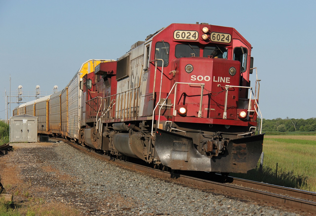 As soon as I turned on my scanner after done work at a site in Galt, I heard SOO 6024 West getting a clearance to Puslinch. As the day was bright and sunny, and I was already in the area, this was a no-brainer. Not many of these bad boys left. SOO 6024 leads CP 9710 and solid autoracks comprising of CP train 255, departing Wolverton after completing their work at 18:44. Note, the guy in the cab holding a sub :)