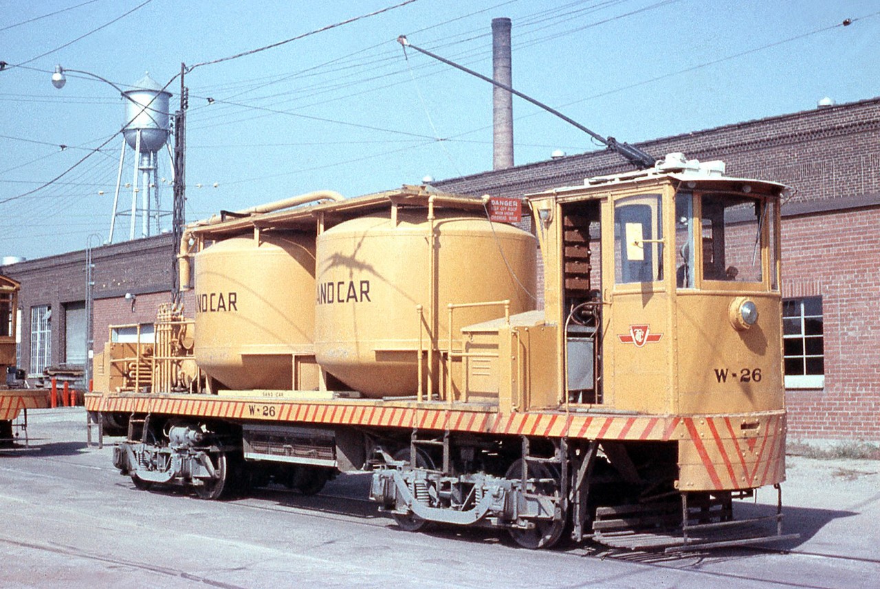 The Toronto Transit Commission's "Sand Car" W-26 is pictured at TTC's Hillcrest Shops complex off Bathurst Street near Davenport. Sand is used by streetcars for extra traction on the rails, and often times an operator would have to top up or add more sand to their car during a shift. The sand car traveled the streetcar system across the city, delivering sand to the various carhouses or barns that the streetcar fleet operated out of. When trucks took over the sand deliveries a few years later, W-26 was retired and scrapped in 1967.