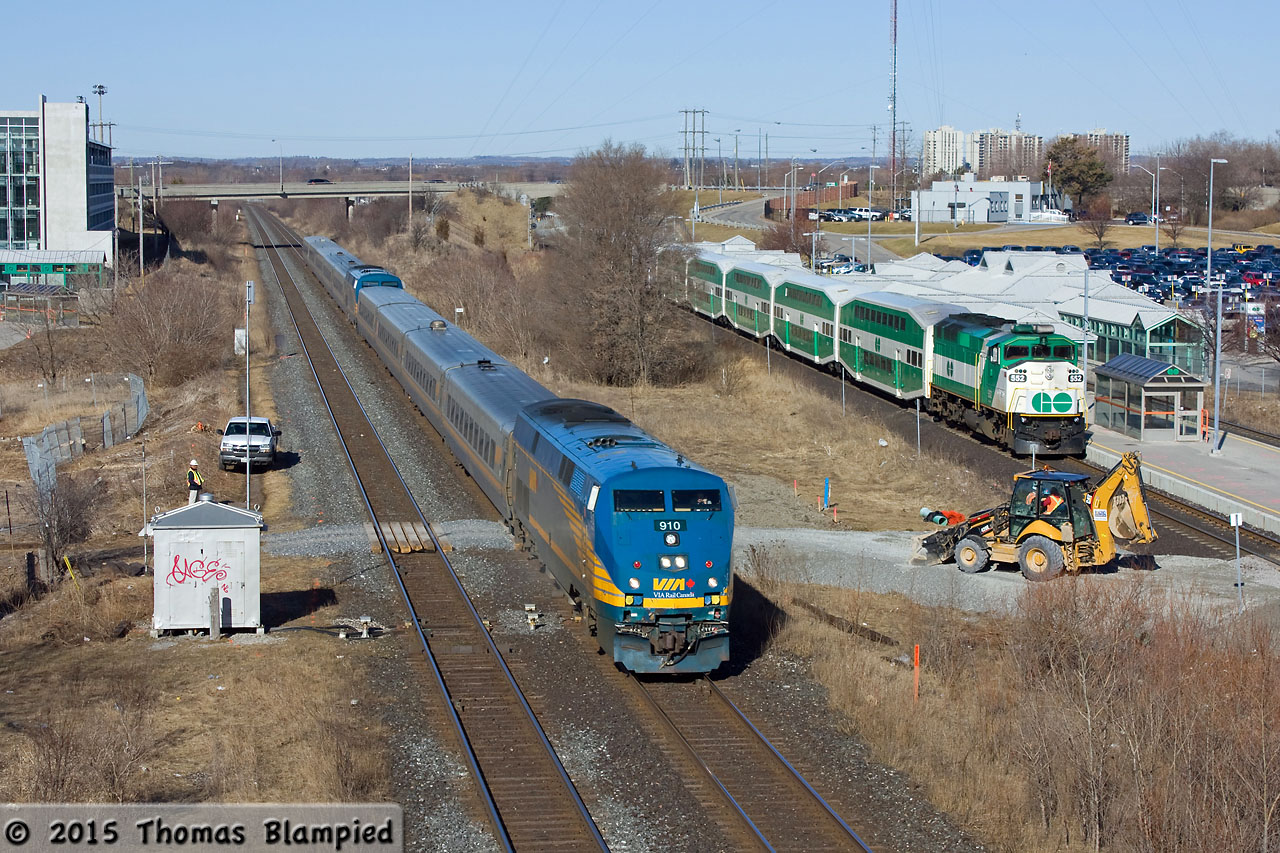 Construction crews are just breaking ground on the new pedestrian footbridge connecting the Whitby GO station with the south parking lot. As the CN foreman performs a roll-by inspection of the VIA J train, the hourly eastbound GO train rolls into the station.