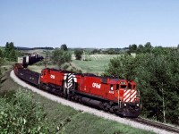 On our Labor day weekend 1978, we walked down the track to a nice curve to setup for the westbound Canadian and were surprised when 2 big consecutively numbered M636's leading an eastbound freight into Toronto showed up first.  