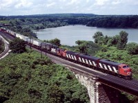 Believe it or not, this is the steel train for June 28, 1986.  We traveled to Hamilton expecting to shoot the street running on Ferguson Ave, but instead they backed out of the yard and went up thru Dundas.  Maybe because of the extra loads they had (trailers).  If you look close you will find the mid train caboose typical of the operation for running around the train.  We were disappointed to not get the normal street operation, but even in 1986, where do you shoot an A-B-A lashup (too bad we got the geep).  