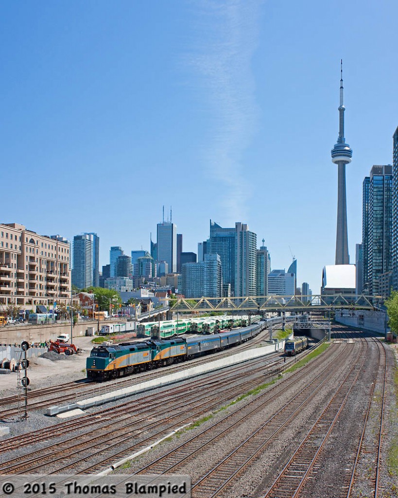 This has not been a good summer for VIA Rail's Canadian. Countless CN detours and other delays have forced the flagship transcontinental train to operate on a revised schedule, often leaving Toronto 12 hours late. On the other hand, this has given photographers the chance to catch the train in a variety of locations which would usually have been impractical. On June 3, train 1 is seen leaving Toronto 13 hours later than planned. Just to the right, one of the new Union-Pearson Express trains heads for Union Station.