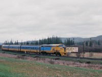 
...and in the mid eighties the thought was that the weekly 44 passenger  *   trains serving CN Washago was minimal service...ha...wrong... 
<br>
<br>
Here is Saturday only ONR conventional train #120 ( Northlander equipped) on the approach to Huntsville ( or ? ) with converted FP7A #1987 ( the former green & yellow #1510).
<br>
<br>
That is the two lane highway #11 at left ( now Regional road #592 ? ), prior to the four lane divided highway.
<br>
<br>
...And from what I remember Granma Lee's was a neat place...
<br>
<br>
  *  those weekly 44 trains at Washago: 14 VIA #9 & #10 ( Toronto section Canadian); 14 ONR – VIA pool trains #128 & #129 Northland; 12  ONR #121 & #122 Northlander and ONR weekend trains #120, #123, #124 ( shown on the Timetable as conventional, but Northlander equipped).
<br>
<br>
May 21, 1983 Kodachrome by S.Danko.



