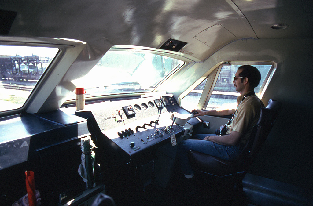 A rare look inside the cab of Bombardier's LRC demonstrator locomotive JV1, while at CN's station in Sarnia ON in May of 1975. Posed inside is my railfan friend Ken Borg, trying out the right-hand seat and then-modern engineer's controls.  Taken while the BBD demo LRC JV1 and coach JV2 were test-running on CN Tempo trains in the Toronto-Sarnia corridor, a view of the sleek modern exterior can be found here: http://www.railpictures.ca/?attachment_id=19855.