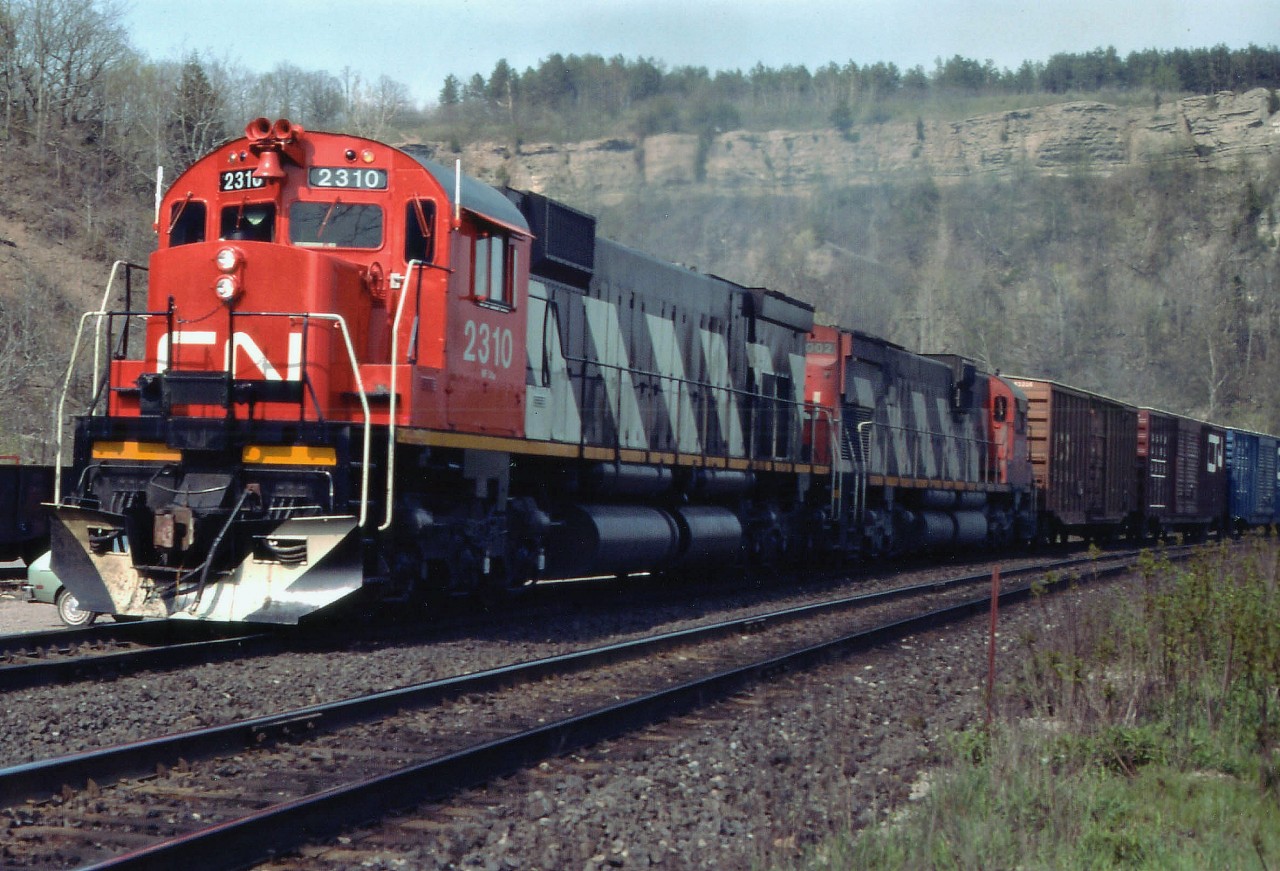 The likes of these beasts we shall never see again on Canadian mainline service, and we are all so much poorer for it........Lead unit MLW M-636 #2310, looking good in her relatively new paint, ended up on the Arkansas & Missouri Rwy; and trailing MLW C-630M #2002 I believe was scrapped. This view was captured just before the westbound move passed the old Dundas station. The clamouring of these majestic units as they climbed the 9 mile grade along this route was unforgettable. I can still hear them:o)