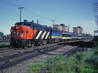 I was a job-hunting recent university grad when I photographed CN FPA-4 6767 leading train #11 (I think this would be the Scotian) rolling past the Bens Bread warehouse  with the Fairview engine terminal and car shops in the background. Two year old Via has managed to get about half the equipment on this train repainted into blue and yellow. 