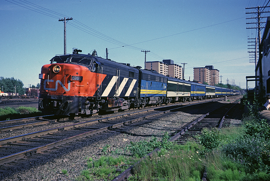 I was a job-hunting recent university grad when I photographed CN FPA-4 6767 leading train #11 (I think this would be the Scotian) rolling past the Bens Bread warehouse  with the Fairview engine terminal and car shops in the background. Two year old Via has managed to get about half the equipment on this train repainted into blue and yellow.