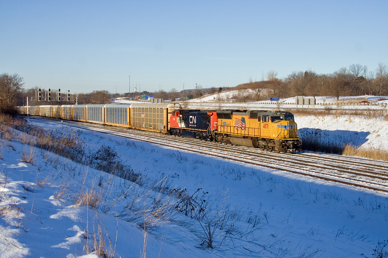 UP 4871 and CN 2199 guide empty auto train 276 through Snake