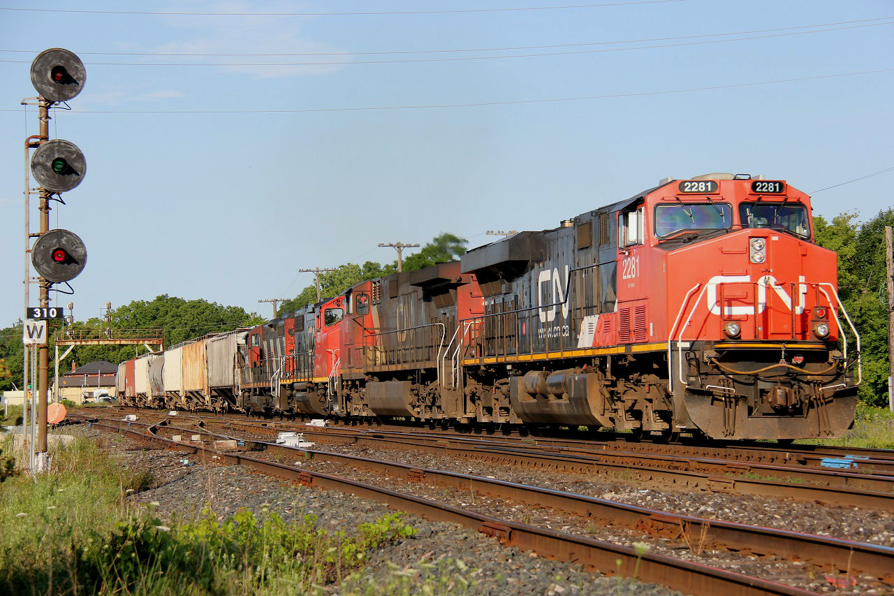 CN 435 rumbles into the slowly setting summer sun through Paris with four locomotives - CN 2281, IC 2711, CN 4761 and CN 4115; two big ones up front and two smaller ones trailing. Time - 18:51.