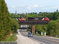 An eastbound freight crosses the bridge over Duffins Creek and the aptly-named Church Street.