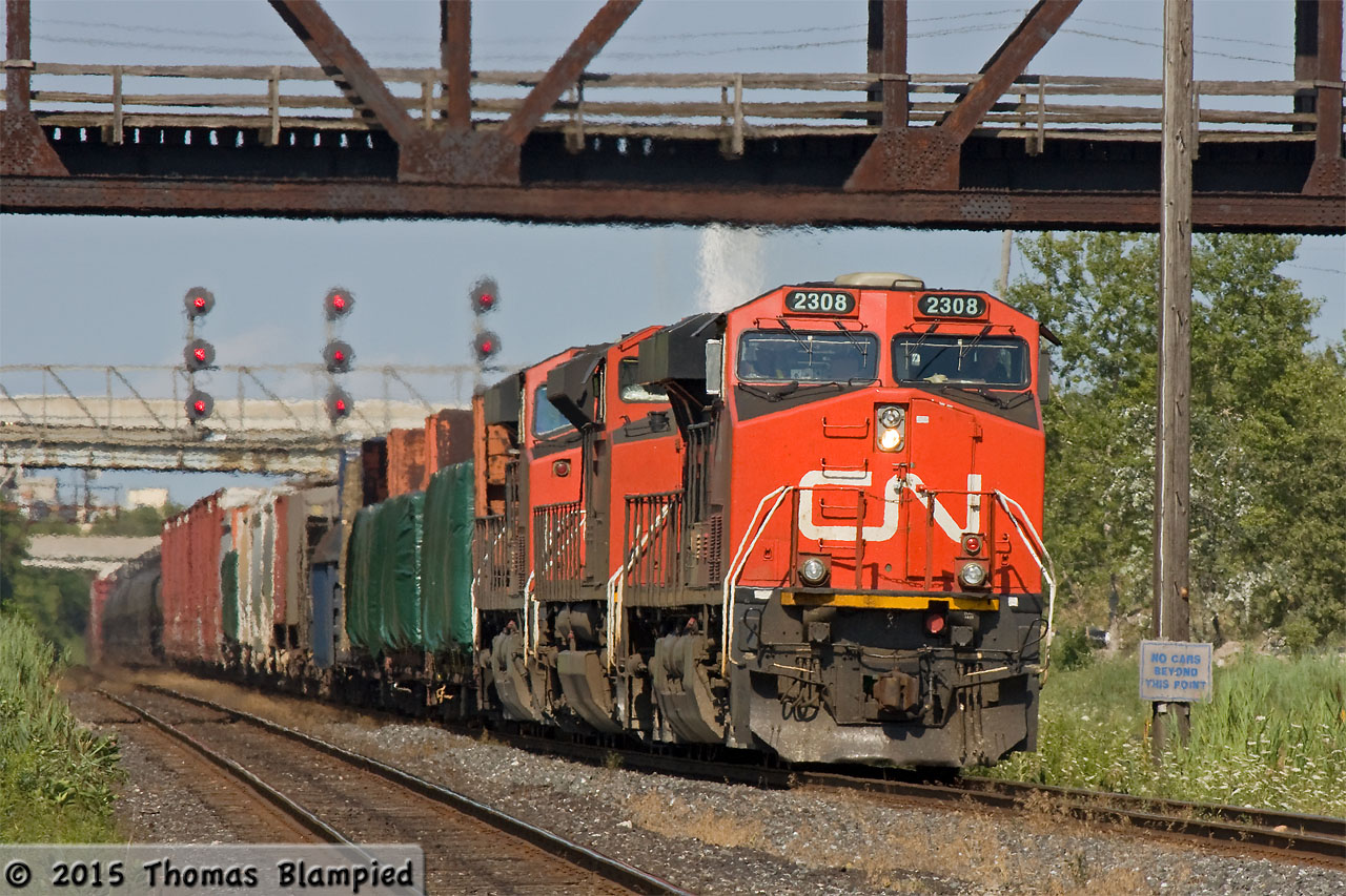 The ripples betray the heat of a summer afternoon as CN 2308 leads 8825 and 2243 elephant-style through Oshawa.
