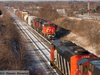 CN 2316 leads an eastbound past westbound CN 5556 on a frigid December day.