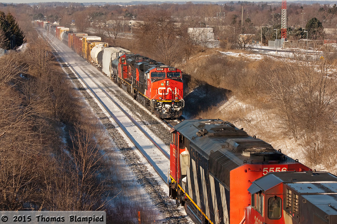 CN 2316 leads an eastbound past westbound CN 5556 on a frigid December day.