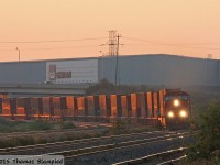 With the rising sun just catching the containers, CN 2551 leads one of the early morning westbound intermodals.