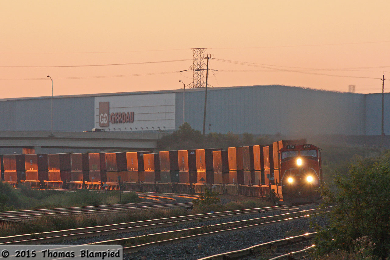 With the rising sun just catching the containers, CN 2551 leads one of the early morning westbound intermodals.