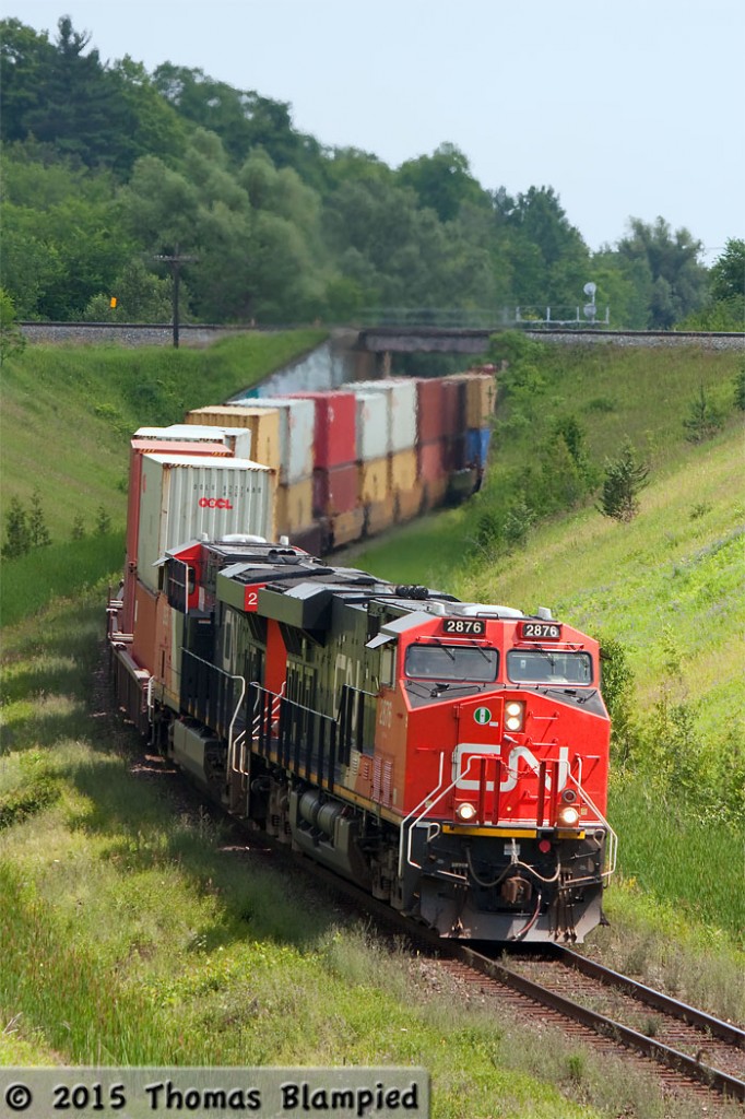 It doesn't look like much, but the grade at Beare takes a toll on all westbound traffic. I first learned of this location nine years ago, but I had never been able to visit it. Beare is a great spot as the CP Belleville Sub crosses over the CN York Sub in a rural setting with excellent sight lines. Unfortunately, the heavy road traffic on Plug Hat Road does not make this a pleasant location to stand for long periods of time. I survived long enough to see two trains: one CN and one CP.   In this image, CN 149 is crawling up the grade with a 572-axle train. About a mile up the line, the conductor was pleading with the RTC to line all the tracks in anticipation of the 14,000 ton train. As far as the crew were concerned, once 149 stopped, it wasn't going to start again.