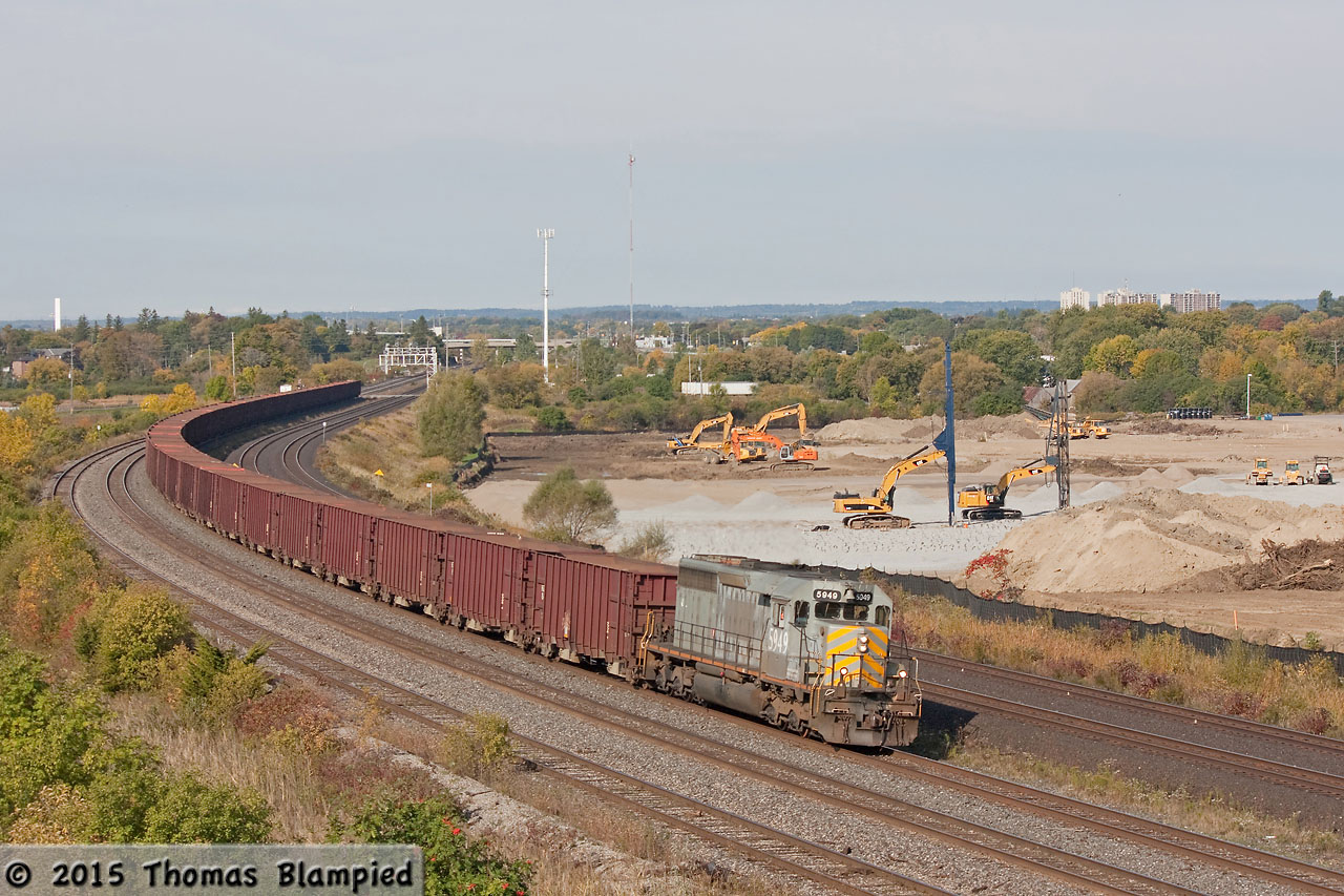 A ballast train rolls past the site of the future GO maintenance facility in Whitby. Three years later, the construction site looks just about the same!