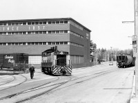 Canadian Pacific SW1200RS 8161 switches the Seagram's Distillery plant in Waterloo. The locomotive is coming back onto the street-running portion of the Grand River Railway line on Caroline Street, at Mile 15.4 of GRR's Waterloo Sub. The GRR and LE&N were operated as an operating division of CPR, and while the power was lettered CP, in the timetables and on the Preston facilities GRR and LE&N were used.<br><br>8161 was one of the trio of regularly-assigned GRR units 8160-8162, that operated on CP's old Electric Lines (GRR and LE&N) based out of Preston. When one went to Toronto for maintenance, it was always insisted that "their" unit be returned back to the GRR (a lot of the time if a unit stayed at an outpost for an extended period of time, the crews took better care of it).<br><br>The Seagram plant, which was the original Seagram distillery built during 1857 in Waterloo, closed in 1992 and has since been converted to condos and office space. Street-running along Caroline St. ended in July 1993 when the last train lead by 8161 and sister 8162 traversed this GRR trackage. 8161, not rebuilt in the 1200-series rebuild program of the 1980's, was sold off in 2004.