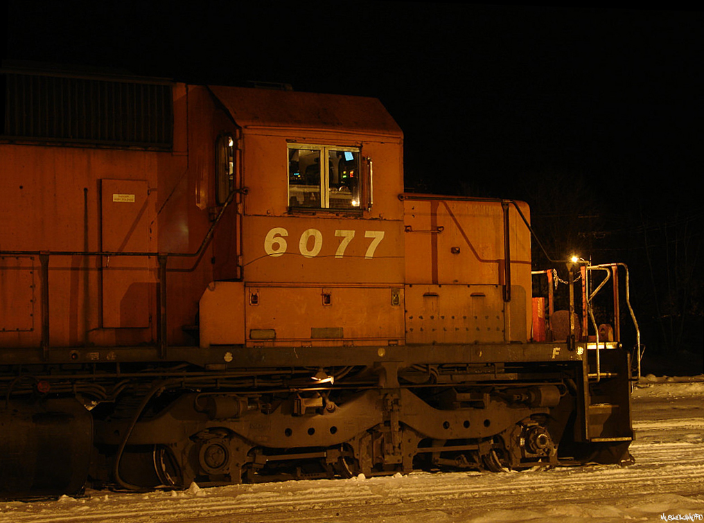 CP 6077 South sits under the lights in the heart of MacTier waiting for a fresh crew to Toronto, just after 21:00 on a bitter cold December night in 2007. Very shortly the Toronto crew will settle in and depart Southwards with the "steel train" from Sudbury to Hamilton.