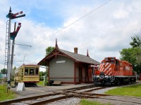 CP 1608 is running long hood forward after heading to the Des Bouleaux spur to do some tree trimming and has just cleared the diamond in front of Barrington Station at Exporail. MTC 1959 is finishing its station stop and will soon continue its trip around the museum grounds.