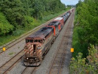 CN 323 has an all-cowl lashup with BCOL 4608 leading CN 5538 as it approaches Taschereau Yard on its way back from St. Albans, Vermont. The left numberboard is held in place by duct tape!