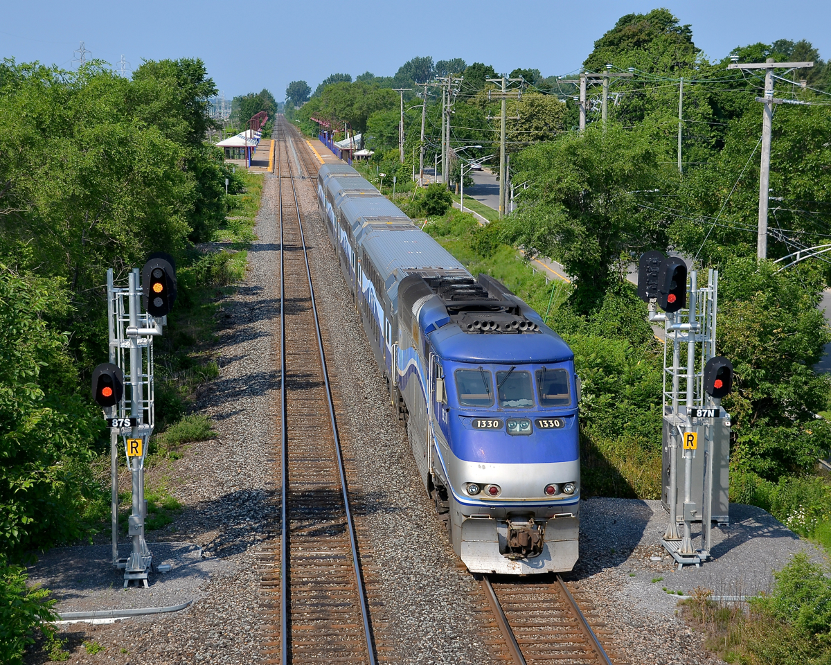 Approaching Cedar Park station. AMT 51 approaches Cedar Park station with AMT 1330 pushing. It is passing a fairly new set of signals.