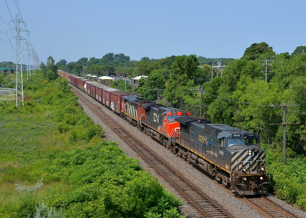 CN 372 has a BC Rail leader and another mid-train (BCOL 4646, CN 2600, CN 2406 & BCOL 4651 DPU) as it passes through Pointe-Claire, past MP 13 of the Kingston sub.