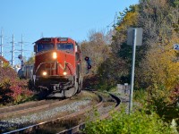 CN 327 with IC 2697 and CN 2115 is passing MP 22 of the Kingston Sub on Île Perrot, just west of the island of Montreal. CN 327 will set off cars at Coteau and then head to Huntingdon where a CSX crew will take the train south to Massena.