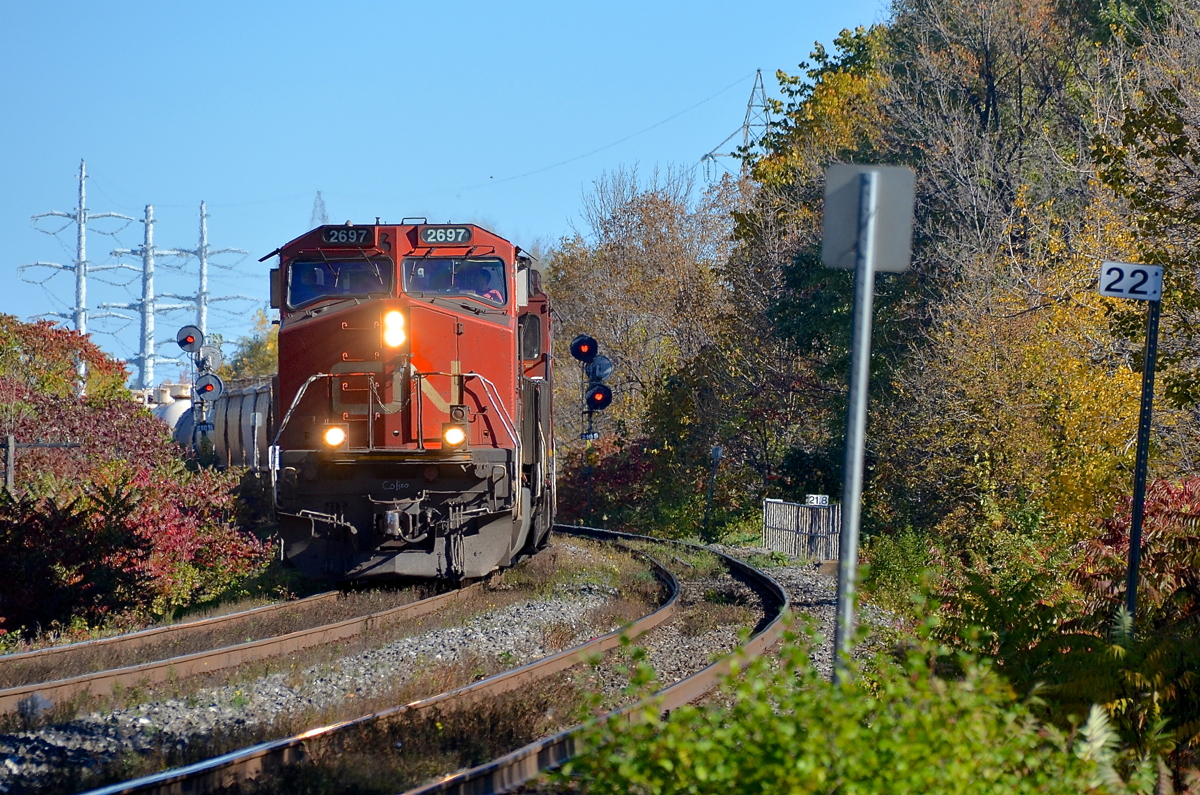 CN 327 with IC 2697 and CN 2115 is passing MP 22 of the Kingston Sub on Île Perrot, just west of the island of Montreal. CN 327 will set off cars at Coteau and then head to Huntingdon where a CSX crew will take the train south to Massena.