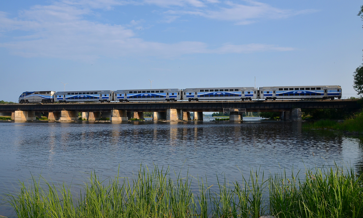 AMT 55 is westbound over the Ottawa River with AMT 1330 pushing four multilevel cars.