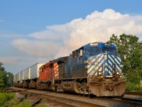 <b>Peace!</b> The engineer gives two fingers up on lead unit CEFX 1019 as CP 133 passes through Dorval on a humid but mostly sunny evening. Trailing is workhorse SD40-2 CP 6011. 