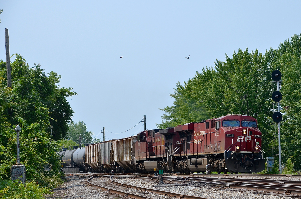 CP 551 has CP 8729 & CP 9837 and three buffer cars as it passes CP's Lasalle Yard. The American crew ran out of hours before getting to Montreal, so a Canadian crew was taxied down to St-Mathieu to bring the train in.