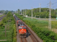 A late and very lengthy CN 377 (708 axles) is through Pointe-Claire with CN 2808, CN 2859, CN 8812 at the head end and CN 2340 mid-train.