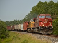 CP 9735 South leans into the bend at Mile 66 MacTier sub with train 420-03 in hand, trailing is UP 9809, built as CNW 8705 in 1994.