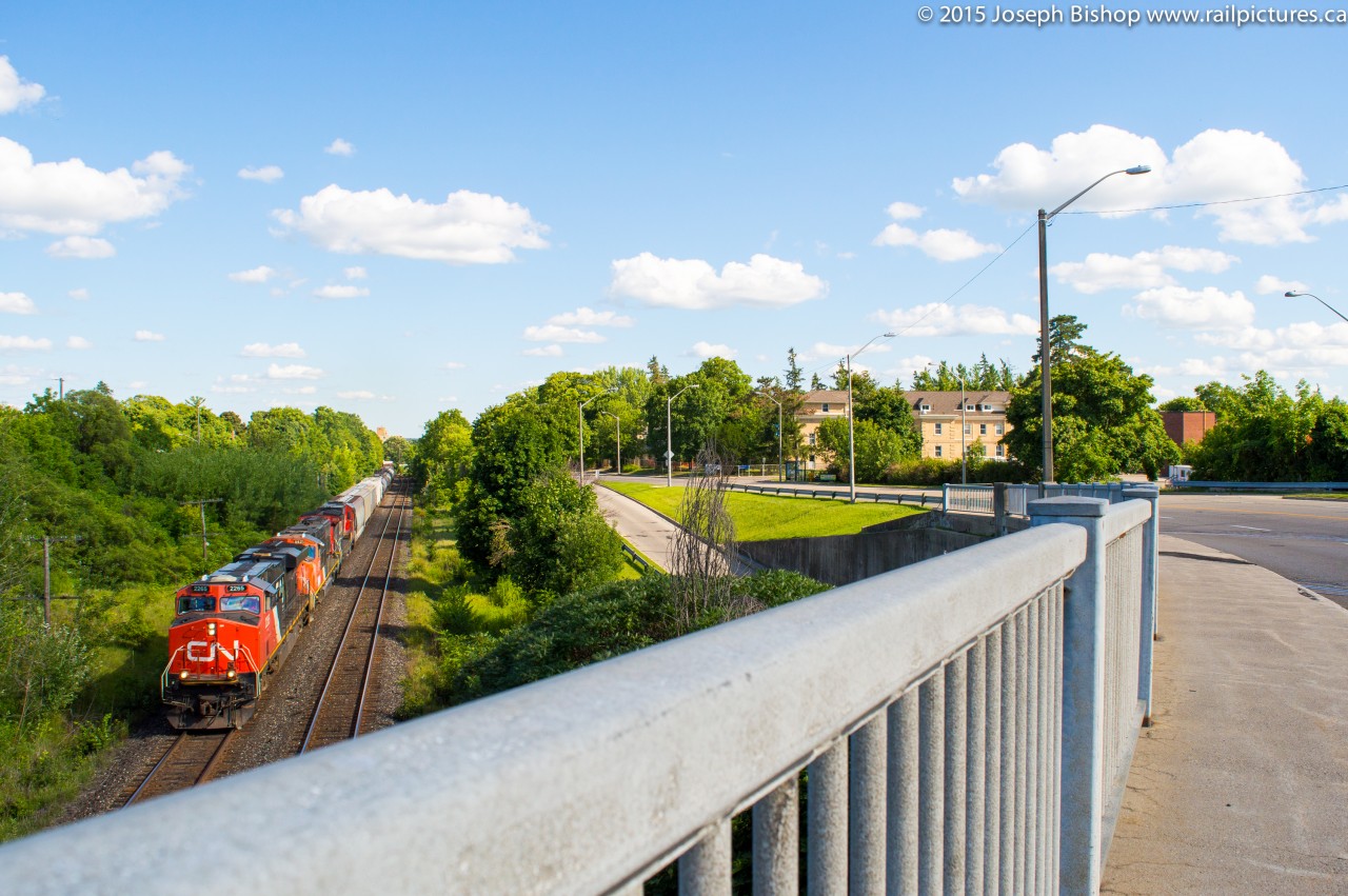 CN 435 throttles up out of Brantford with a trio of CN units.  They are pictured approaching the Paris Road overpass, being a boring consist I went for a different angle.