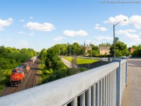 CN 435 throttles up out of Brantford with a trio of CN units.  They are pictured approaching the Paris Road overpass, being a boring consist I went for a different angle.