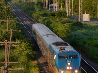 VIA 39 is led by VIA 920 as it passes through Pointe-Claire with three stainless steel cars.