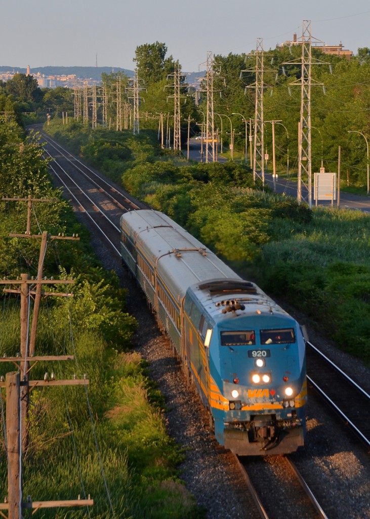 VIA 39 is led by VIA 920 as it passes through Pointe-Claire with three stainless steel cars.